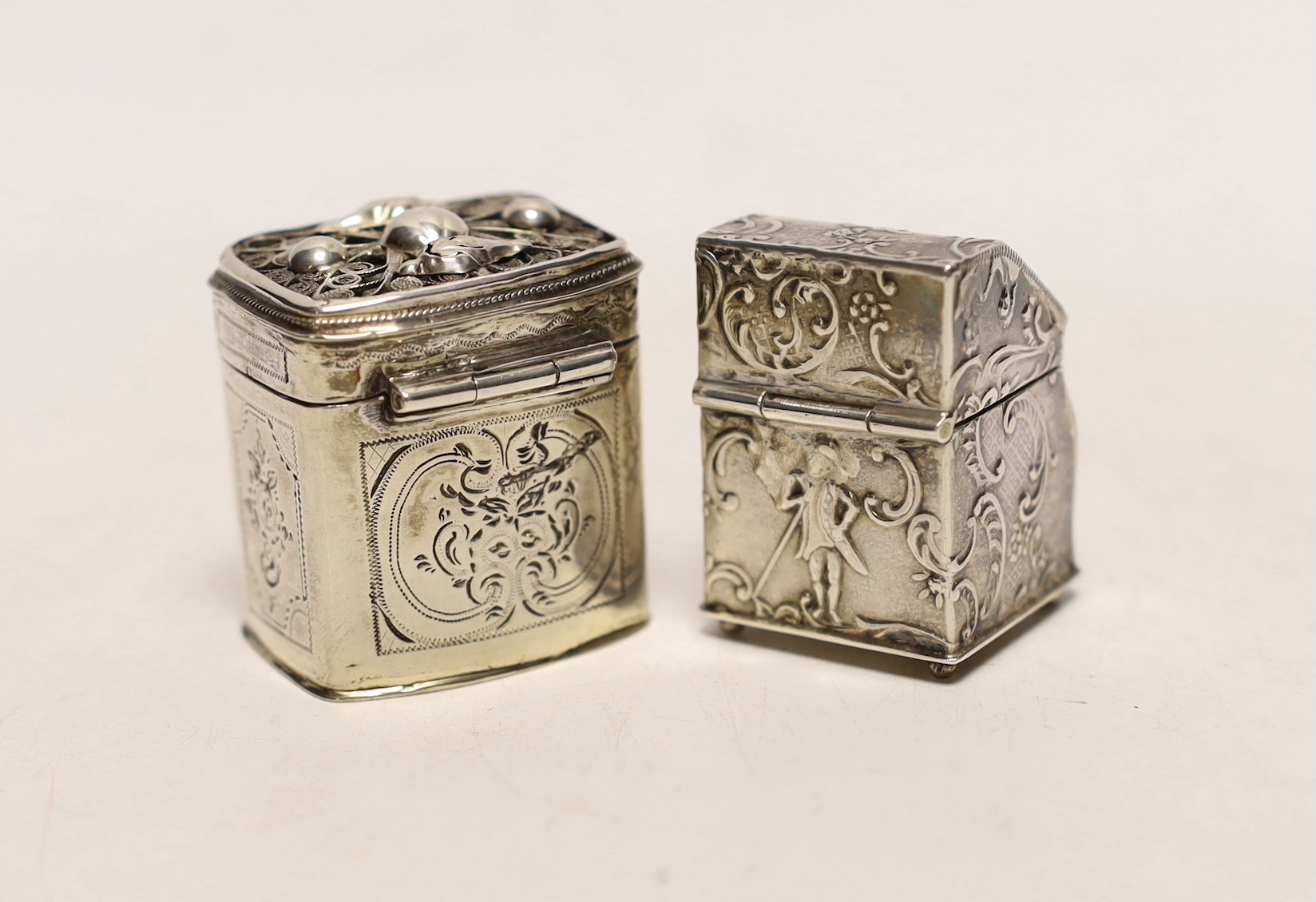 Two 19th century Dutch white metal snuff boxes, one of bureau form, on ball feet, 39mm.